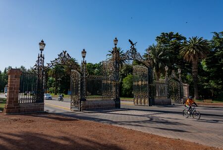 MENDOZA, ARGENTINA - NOVEMBER 16, 2019: Long shot of the magestic  gates from General San MartÃ­n Park in Mendoza, Argentina. Built in1907, these iron gates are the main entrance to the Parkのeditorial素材