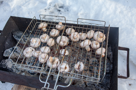 Grilled mushrooms cooked in a brazier, top view, close-up. mushrooms on the grillの写真素材