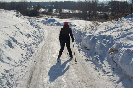 girl skiing down from the hillの写真素材
