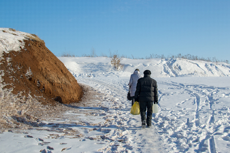 man and woman go in winterの写真素材