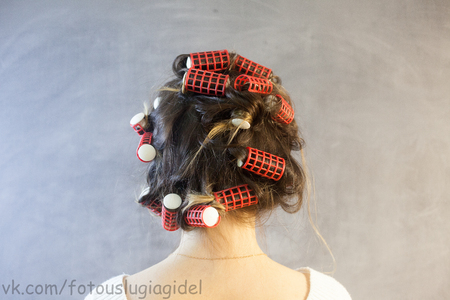 Beautiful woman with hair curlersの写真素材