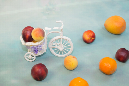 fruit on a light blue background with a decorative Bicycleの写真素材