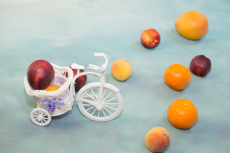 fruit on a light blue background with a decorative Bicycleの写真素材