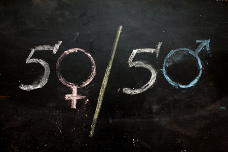 Gender symbols or signs for the male and female sex drawn on a blackboardの写真素材