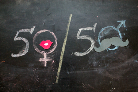 Gender symbols or signs for the male and female sex drawn on a blackboardの写真素材