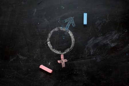 Gender symbols or signs for the male and female sex drawn on a blackboardの写真素材