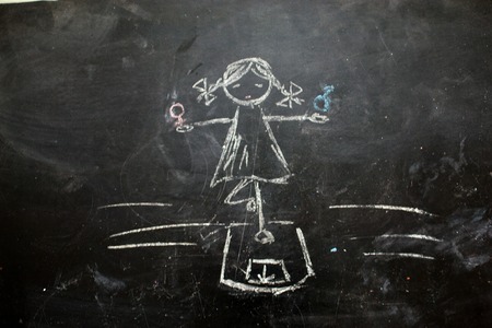 Gender symbols or signs for the male and female sex drawn on a blackboardの写真素材