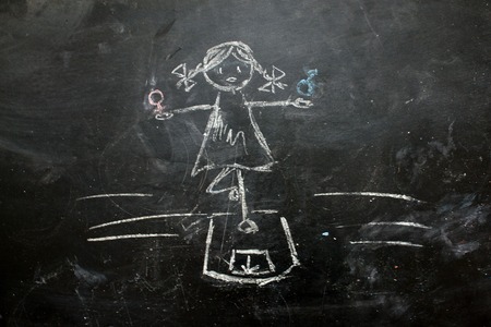 Gender symbols or signs for the male and female sex drawn on a blackboardの写真素材