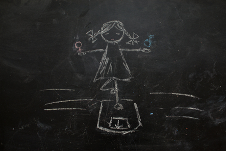 Gender symbols or signs for the male and female sex drawn on a blackboardの写真素材