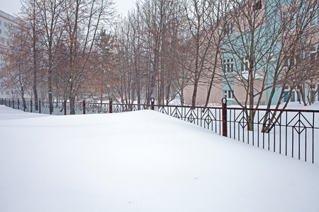 Snow storm in the city, big heaps of snow, cityscape in winterの写真素材