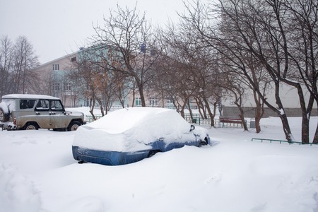 Snow on cars after snowfall. Winter urban scene.の写真素材