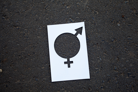 Legs with gender symbol on asphalt, gender conceptの写真素材