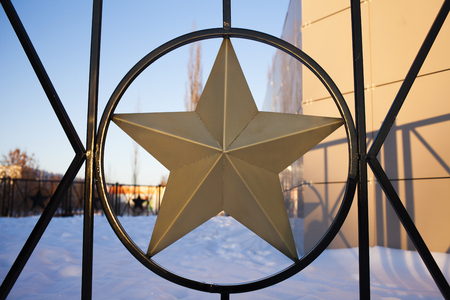 gold star on the fence. star in the Soviet style. iron fenceの写真素材