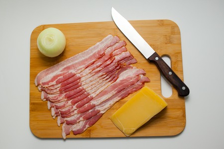 Sliced bacon with salad leaves on the wood backgroundの写真素材