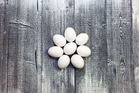 Eggs lay on wooden background. Food ingredient.