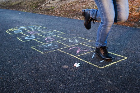Cute girl playing hopscotch outside. Springの写真素材