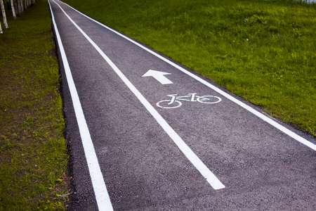 Bike path. Sign white paint on the pavement. Summer. bicycle traffic sign painted on the floorの写真素材