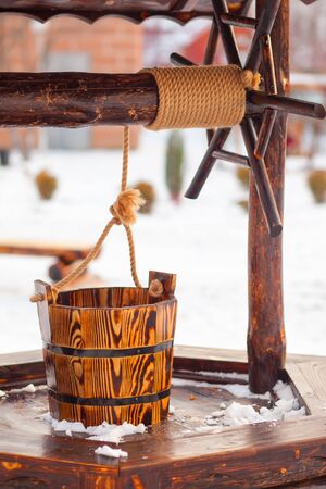 wooden well in garden. Winter. Water wellの写真素材