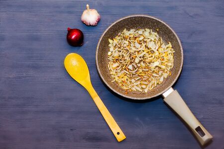 Chopped onion in a frying panの写真素材