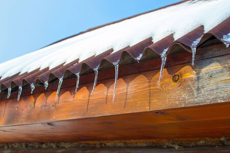 Icicles on the roof of a house. Russia