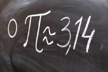 number pi handwritten with white chalk on a blackboard.の写真素材