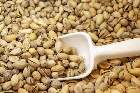 Pistachios. Salted pistachios. White spatula for fillingの写真素材