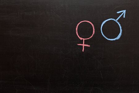 female and male gender symbol on a chalkboard. Copyspaceの写真素材