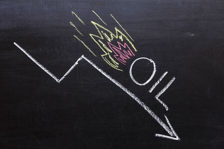 Drawing a down arrow showing falling oil prices in the market
