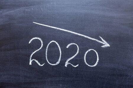 The concept of the crisis of 2020. 2020 on a chalk Board with a down arrow