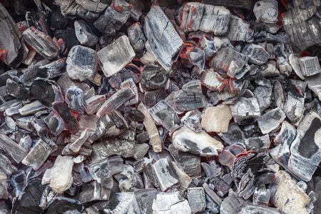 Burning coals in the grill, close up, background, top viewの写真素材