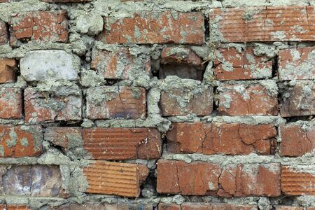 Fragment of an old red brick wall