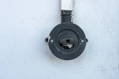 Old style rotary light on a white painted wall