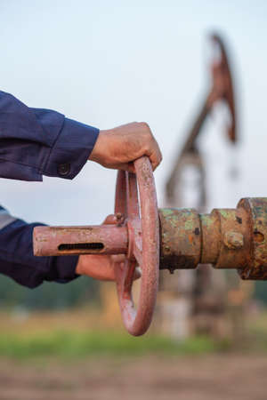 Oilman closes the valve on the pipeの写真素材