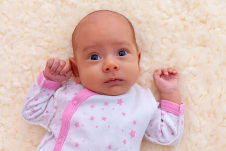 Newborn girl makes funny faces