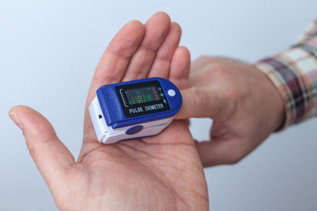 The man checks his oxygen level. Oximeter