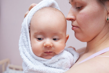 Mom wipes baby after bathing