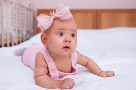 Beautiful newborn baby girl learns to crawlの写真素材