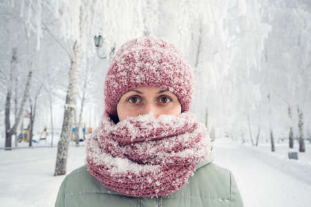 Portrait woman in winter clothes and strong snowing.の写真素材
