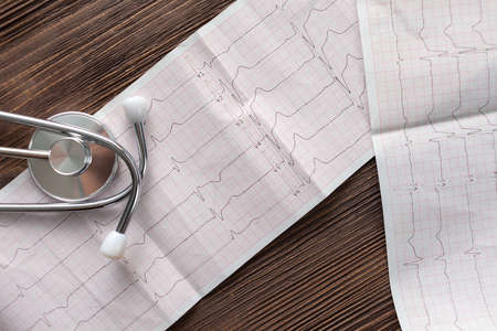 Stethoscope and cardiogram on wood backgroundの写真素材