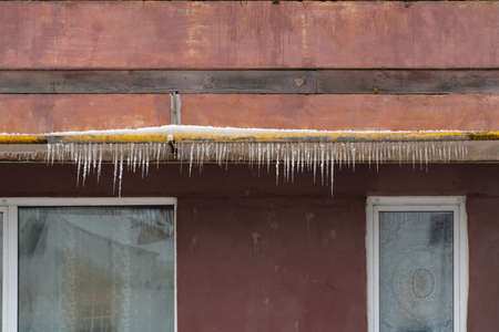 Russia Neftekamsk March 24, 2021: Facade of an apartment building with a gas pipe on which icicles hangのeditorial素材