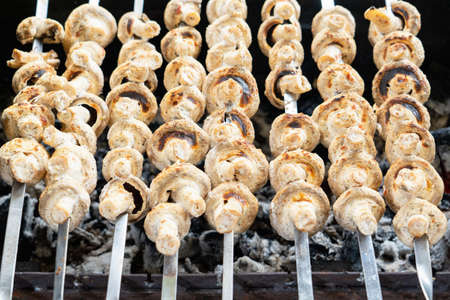Mushrooms marinated in mayonnaise are grilled. A quick snack at a picnicの写真素材