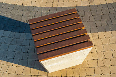 Concrete pouf with a seat made of wooden slats in the city park, top viewの写真素材