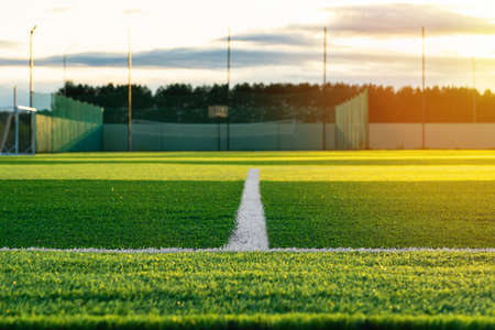 A white line on a football field covered with synthetic plastic lawnの写真素材