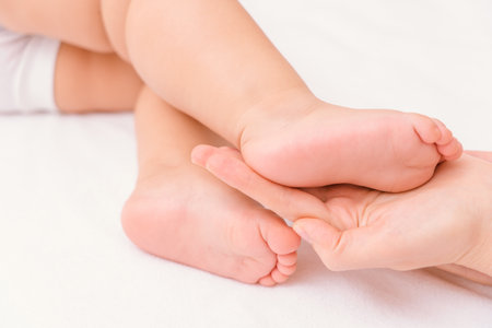 The foot of a newborn baby in the mother's palm, soft focusの写真素材