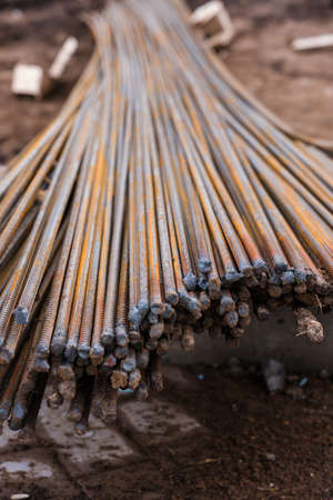 Bundle of rusty rebar on a construction site, selective focus.の素材 [FY310177033303]