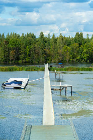 A long pier and a parking lot for speedboats on the river