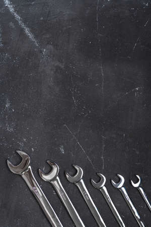 Wrenches on black background with copy space in the center, steel hand working toolsの写真素材