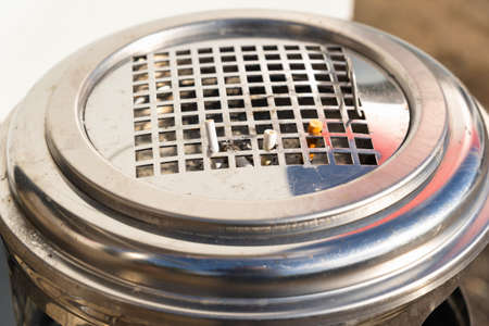 A street metal urn with an ashtray from which cigarette butts stick out. selective focusの写真素材