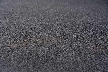 Rubber floor black texture background. Black rubber crumb coating on the sports field. selective focusの写真素材