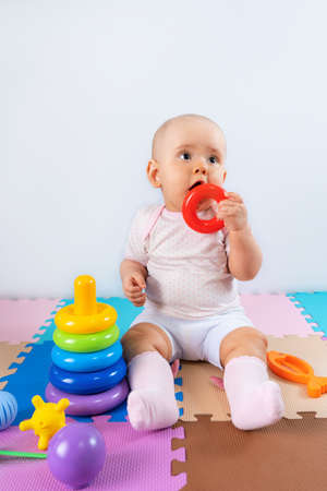 Happy baby is playing with a toy pyramid. Educational toys for toddlersの写真素材